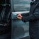 A driver opening the door of a private van